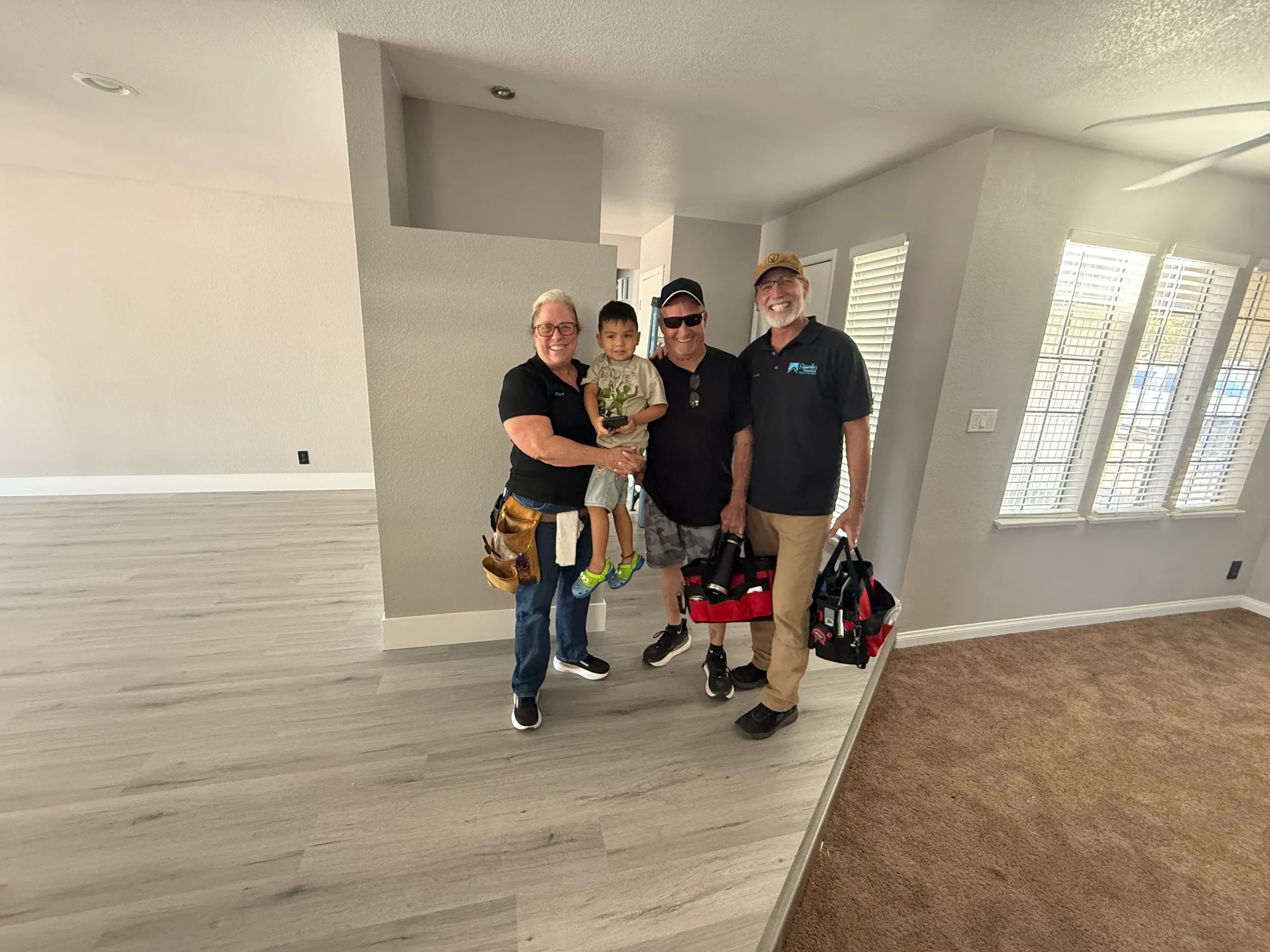 Peri & Billy McCulloch and employee finishing home buyer's inspections with picture of their son